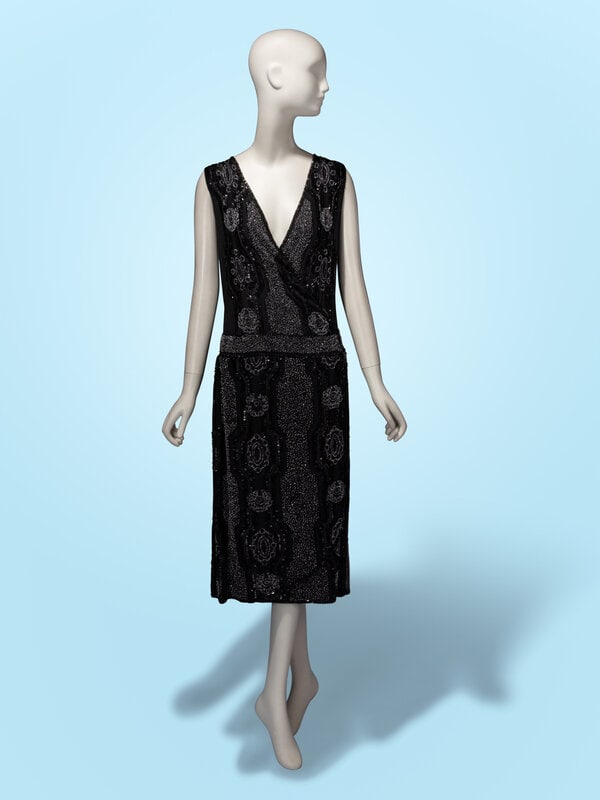 Haute Couture Black Beaded Wrap Dress, c. 1920's: Haute Couture Black Beaded Wrap Dress, c. 1920's Sleeveless wrap dress in black silk crêpe de chine with all-over black and clear bead embellishments. Deep V neckline at front. Drop wa