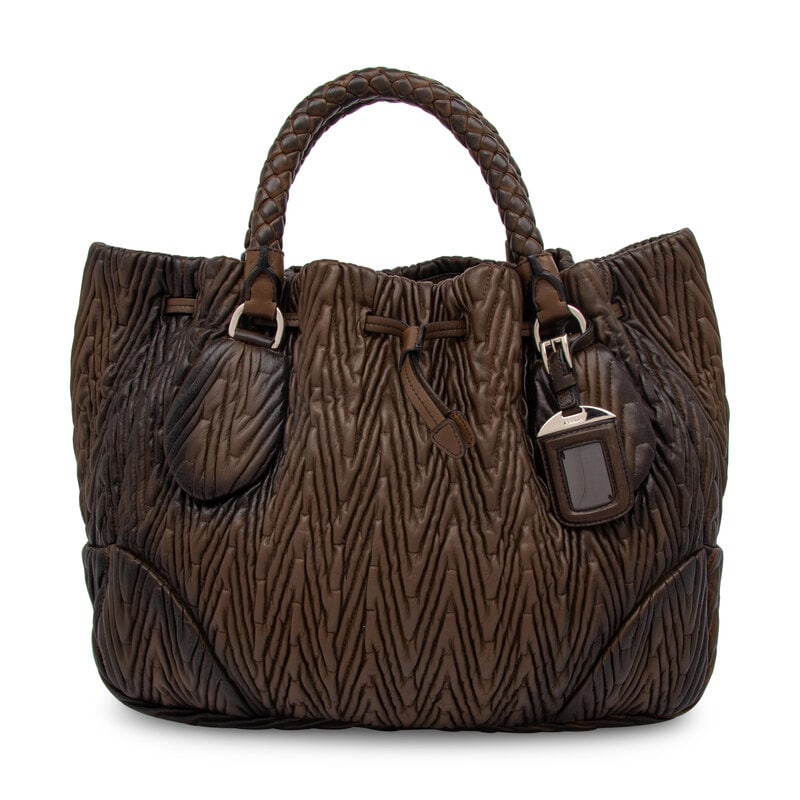 Prada, Chevron Quilted Leather Tote: Prada, Chevron Quilted Leather Tote Shopper tote in chevron-quilted olive green lambskin leather with darkened areas. Drawstring closure, braided leather handles, and removable & adjustable