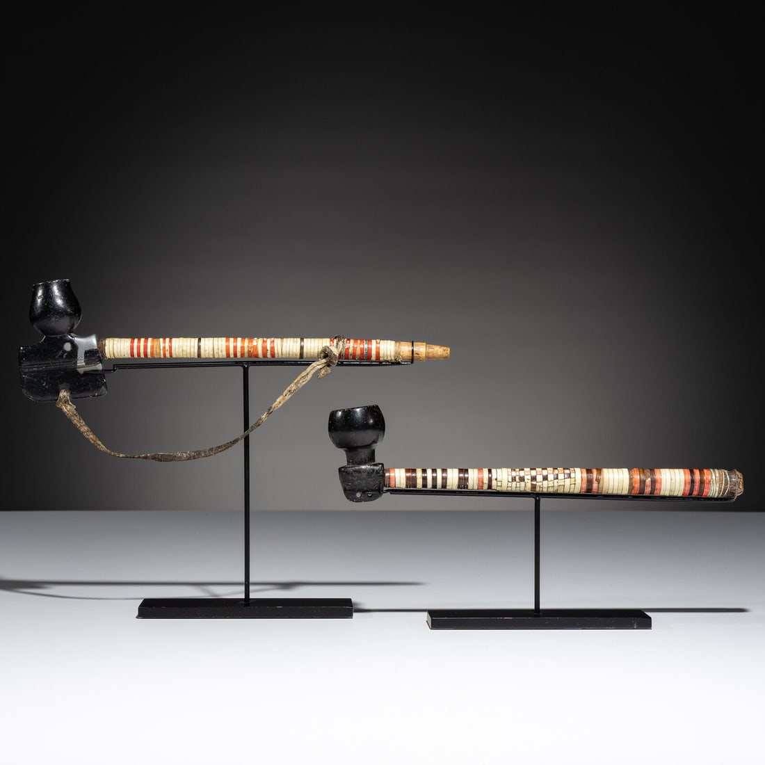 Early Mi'kmaq Quilled Pipes, Exhibited and Published: Early Mi'kmaq Quilled Pipes, Exhibited and Published first half 18th century lot of 2, includes: a wood stem wrapped with cream, red, blue, and purple quillwork; with a tulip-shaped bowl having lead