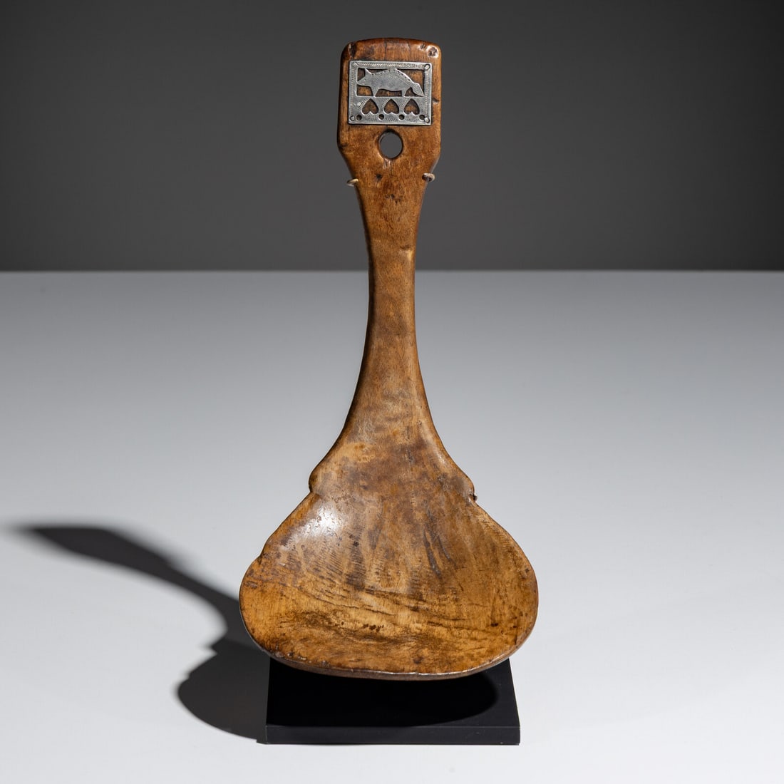 Menominee Feast Ladle, with Trade Silver Medallion, Published: Menominee Feast Ladle, with Trade Silver Medallion, Published mid-19th century elegantly formed, having an hourglass-shaped handle flaring to the scoop; rocker-engraved and cutout silver medallion wit