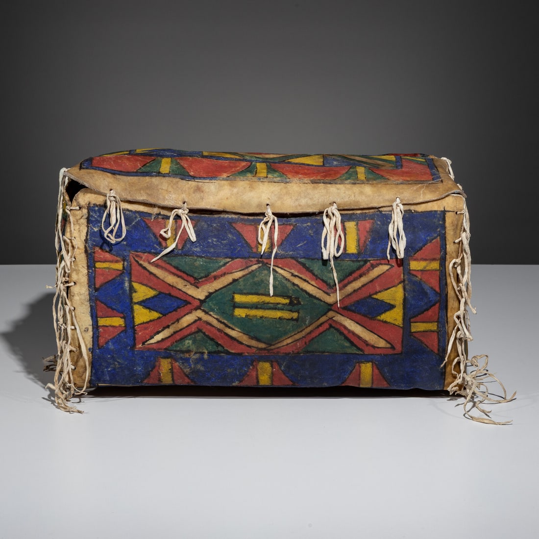 Sioux Painted Parfleche Box: Sioux Painted Parfleche Box late 19th century brightly painted with bold colors of blue, yellow, red, green, and black height 10 inches x length 16 inches x width 9-1/2 inches From an Old Hollywood