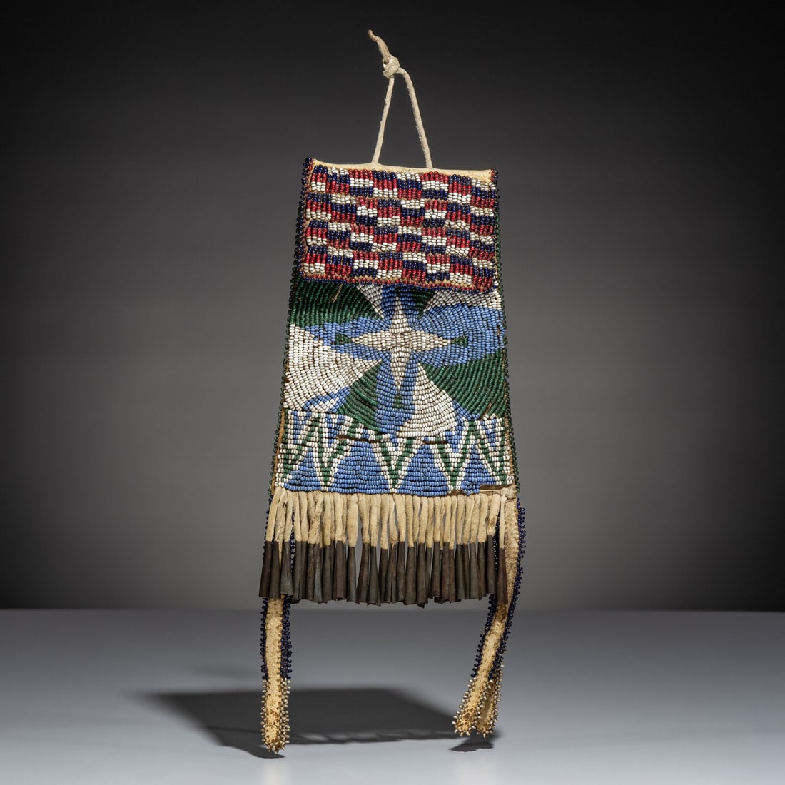 Apache Beaded Hide Strike-a-Light Bag: Apache Beaded Hide Strike-a-Light Bag fourth quarter 19th century sinew-sewn, softly tanned hide with commercial leather backing; beaded in colors of red white-heart, cobalt, white, light blue, transl