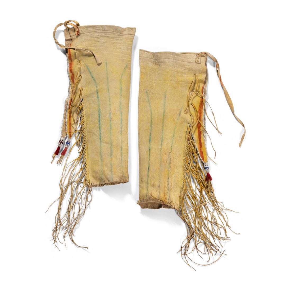 Kiowa Boy's Beaded Hide Leggings: Kiowa Boy's Beaded Hide Leggings early 20th century thread-sewn and coated with yellow pigment; green and orange painted detailing; side tabs with white glass beads and "Peyote-stitch" tassels 