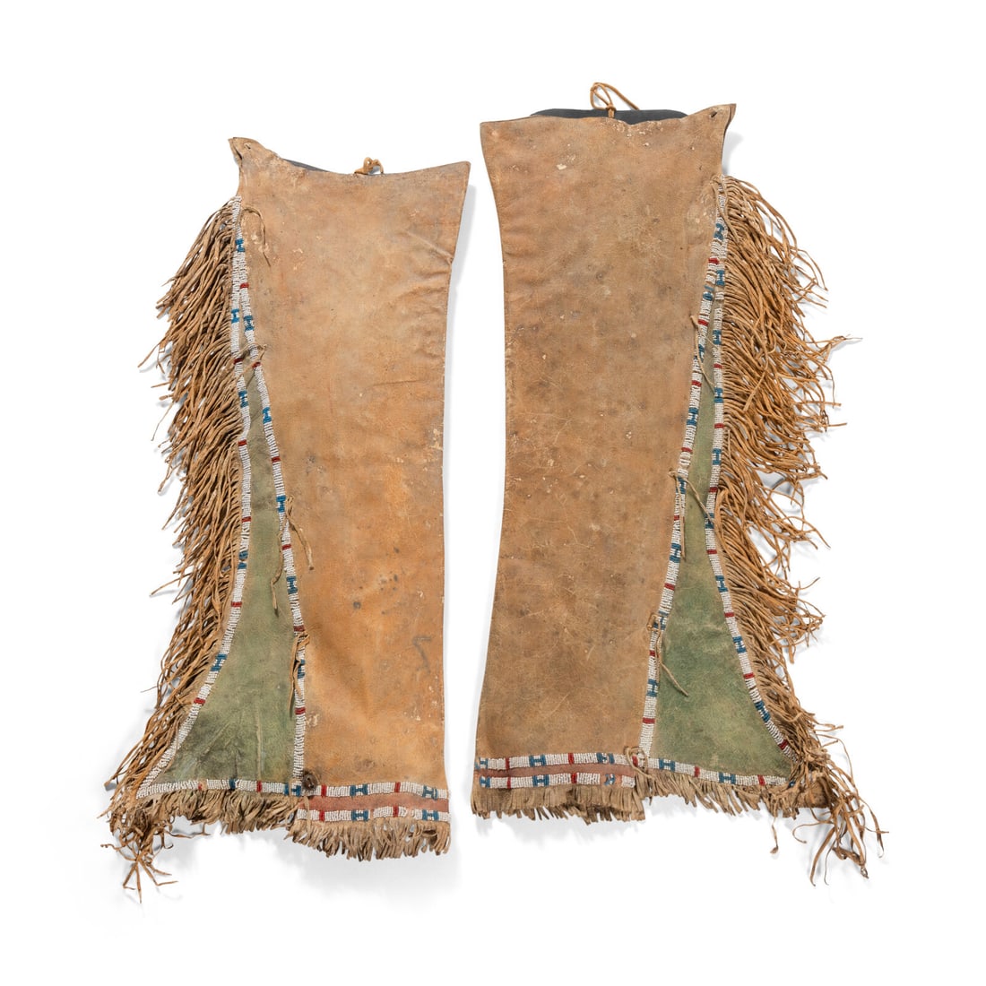 Kiowa Beaded Hide Leggings: Kiowa Beaded Hide Leggings ca 1900 sinew-sewn and beaded in colors of greasy blue, apple red white-heart, and white; hide coated in orange, red, and green pigments length 25-1/2 inches The Ronny and D