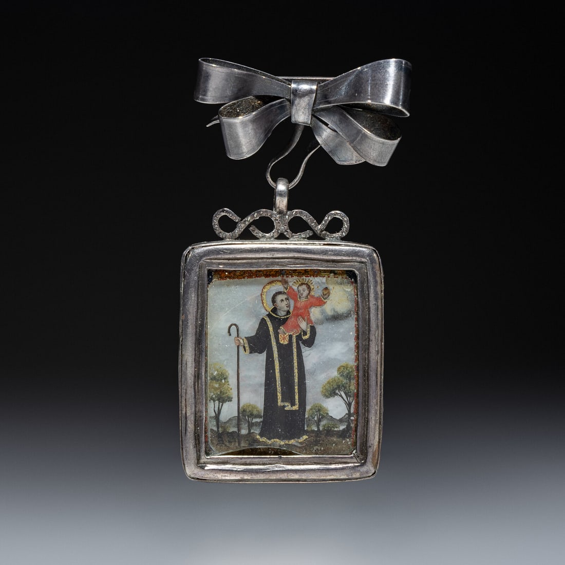 Spanish Colonial Retablo Pin, Relicario: Spanish Colonial Retablo Pin, Relicario ca 1890 silver pin with abalone tile painted on both front and back length 2-1/2 inches x width 1-1/4 inches, weight 15.4 dwt. This lot is located in Chicago.