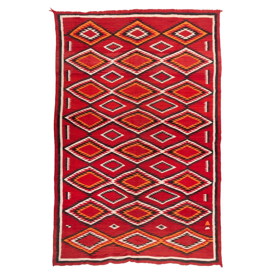 Navajo Western Reservation Weaving [Rug]: Navajo Western Reservation Weaving [Rug] early 20th century featuring bands of serrated diamonds woven in colors of red, orange, cream, and brown 90 x 58 inches From an Old Hollywood Family