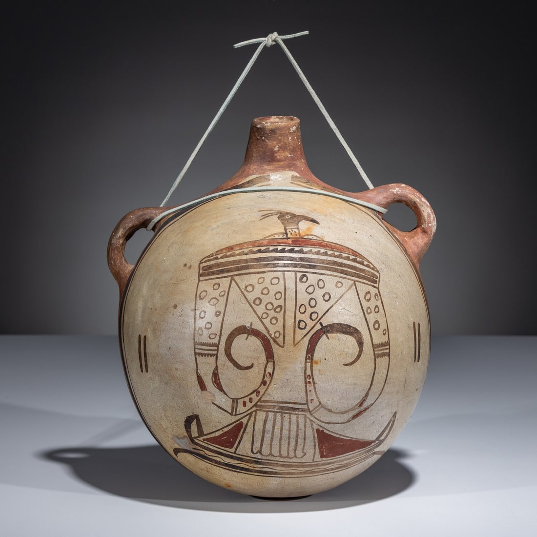 Large Hopi Pottery Canteen: Large Hopi Pottery Canteen first quarter 20th century painted with a Thunderbird having elongated, fierce wings length 11 inches x width 9-1/4 inches x depth 6-1/2 inches This lot is located in Chicag