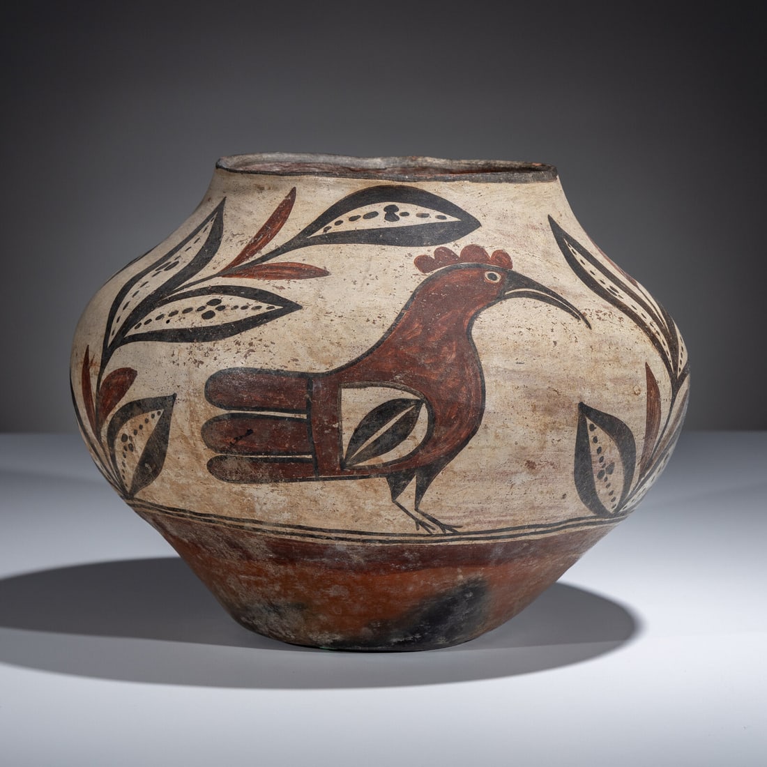 Zia Parrot Pottery Jar: Zia Parrot Pottery Jar late 19th century decorated with three parrots standing amid leafy foliage height 9-1/2 inches x diameter 12-1/4 inches This lot is located in Chicago.