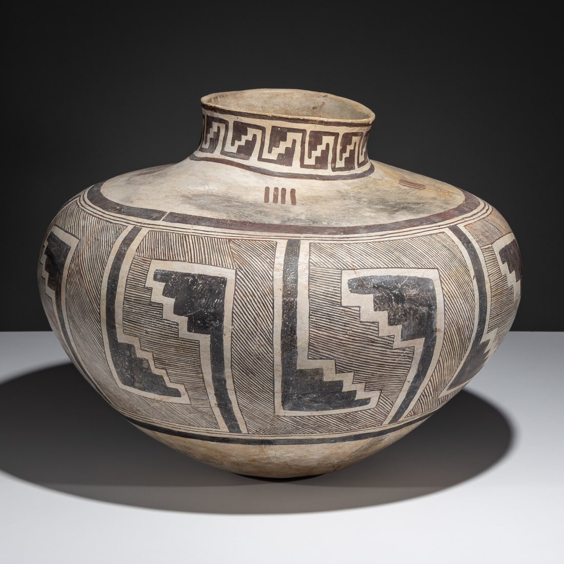 Massive Ancestral Pueblo, Snowflake Black-on-White Pottery Olla: Massive Ancestral Pueblo, Snowflake Black-on-White Pottery Olla A.D. 1175-1325 globular form; having a fine-line design surrounding stepped geometrics height 15 inches x diameter 20 inches From an