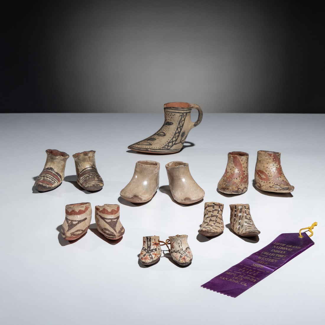 Pueblo Pottery Moccasins, Award Winning Collection: Pueblo Pottery Moccasins, Award Winning Collection first half 20th century lot of 6 pairs and one single, includes: a single, Cochiti moccasin with a crosshatched floral design and handle height 4