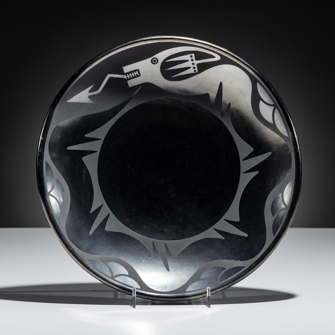 Maria Martinez and Popovi Da (San Ildefonso, 1887-1980 / 1923-1971)) Blackware Pottery Plate, with: Maria Martinez and Popovi Da (San Ildefonso, 1887-1980 / 1923-1971)) Blackware Pottery Plate, with AvanyuJune 1966 gunmetal finish; signed and dated on base height 2 inches x diameter 11-3/4 inches