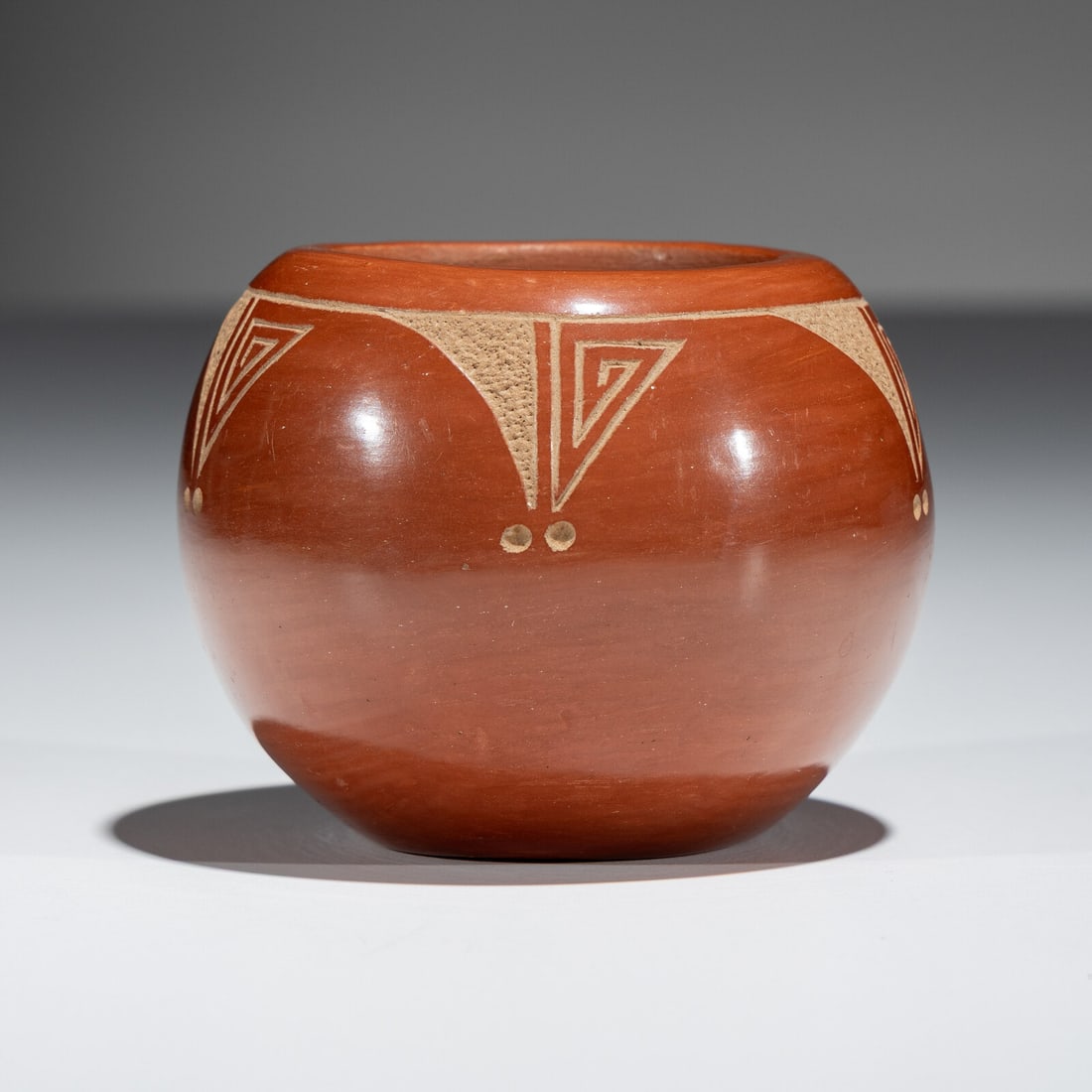 Tony Da (San Ildefonso, 1940-2008) Sgraffito Redware Pottery Jar: Tony Da (San Ildefonso, 1940-2008) Sgraffito Redware Pottery Jar signed on base height 2-1/2 inches x diameter 3-1/4 inches This lot is located in Chicago.