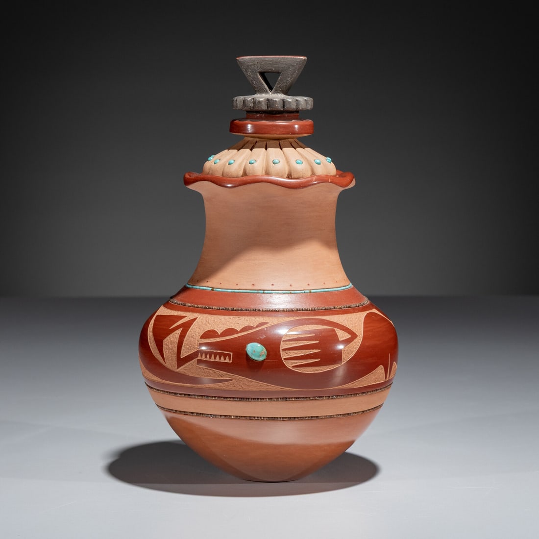 Russell Sanchez (San Ildefonso, b. 1963) Carved Three-Toned Pottery Jar, with Turquoise Beads: Russell Sanchez (San Ildefonso, b. 1963) Carved Three-Toned Pottery Jar, with Turquoise Beads decorated with an Avanyu motif and strands of heishi and turquoise; signed on the base height 6 inches x d