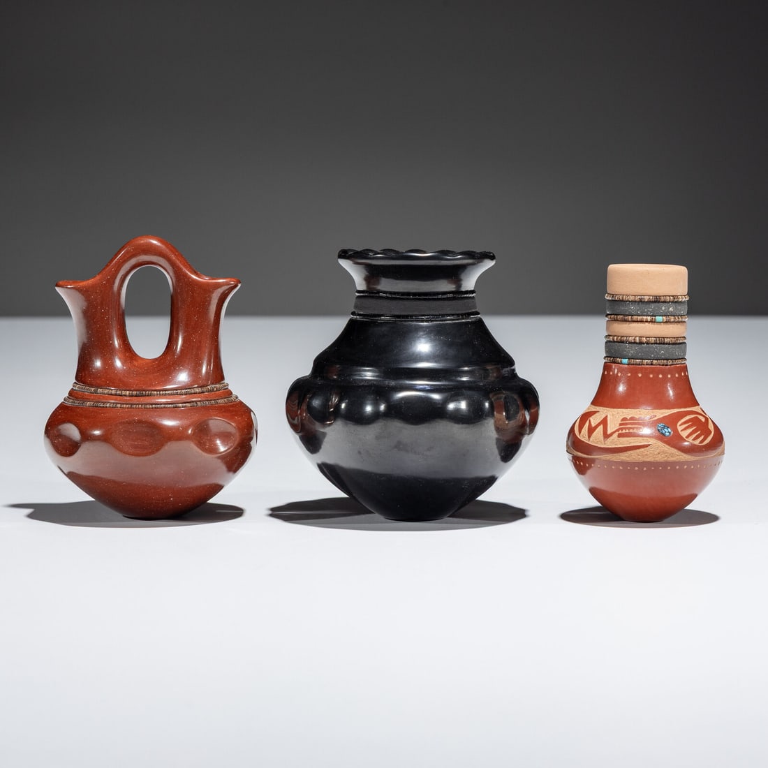 Russell Sanchez (San Ildefonso, b. 1963) Miniature Pottery: Russell Sanchez (San Ildefonso, b. 1963) Miniature Pottery lot of 3, includes: a blackware vase with fluted rim and two strands of black beads; signed on base, height 3-1/2 inches x diameter 3 inches