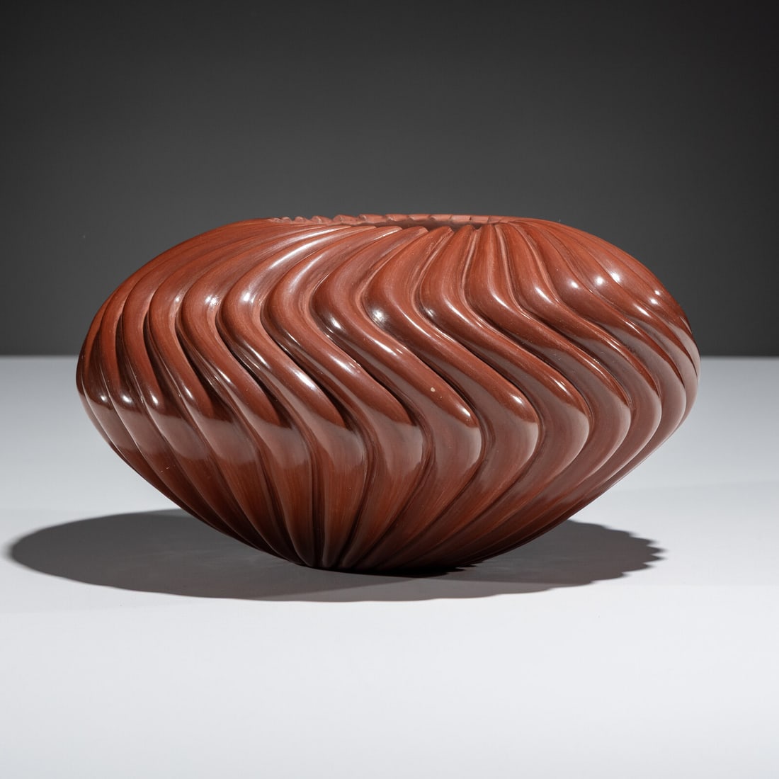 Nancy Youngblood (Santa Clara, b. 1955) Redware Pottery Swirl Jar, 2005: Nancy Youngblood (Santa Clara, b. 1955) Redware Pottery Swirl Jar, 2005 32 ribs; signed and dated on base height 4-1/2 inches x diameter 8 inches Property from the Collection of Dr. Deane and Susan Pe
