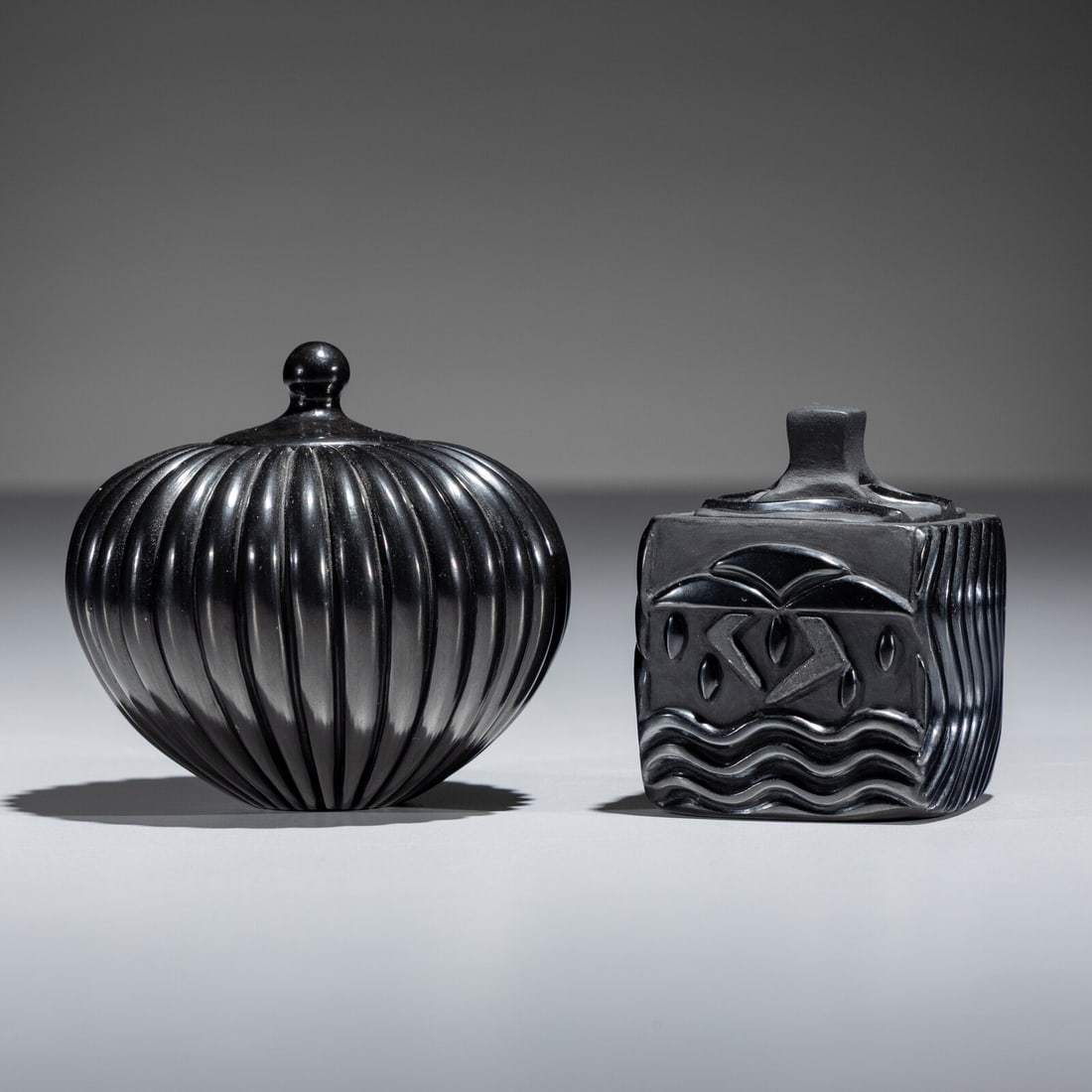 Nancy Youngblood (Santa Clara, b. 1955) Carved Blackware Pottery Jars: Nancy Youngblood (Santa Clara, b. 1955) Carved Blackware Pottery Jars lot of 2, includes: a 32 ribbed jar with lid; signed on base, height 3 inches x diameter 3 inches a lidded box with designed with