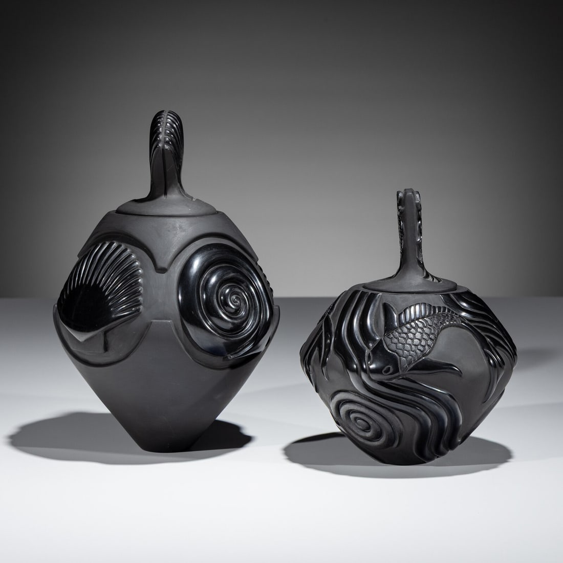 Nancy Youngblood AND Chris Youngblood (Santa Clara, b. 1955 / b. 1989) Carved Blackware Lidded Jars: Nancy Youngblood AND Chris Youngblood (Santa Clara, b. 1955 / b. 1989) Carved Blackware Lidded Jars lot of 2, includes: a jar with shell imagery by Nancy Youngblood; signed and dated 2006 on base, hei