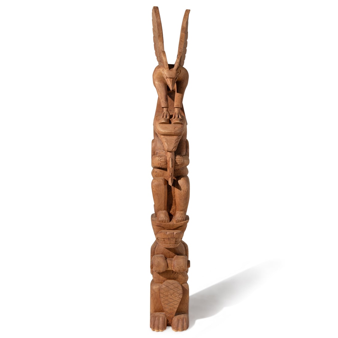 Cicero August (Coastal Salish, b. 1940) Monumental Carved Totem Pole: Cicero August (Coastal Salish, b. 1940) Monumental Carved Totem Pole featuring an eagle, a bear having a fishy snack, and a standing beaver; signed on reverse height 8 feet This lot is located in