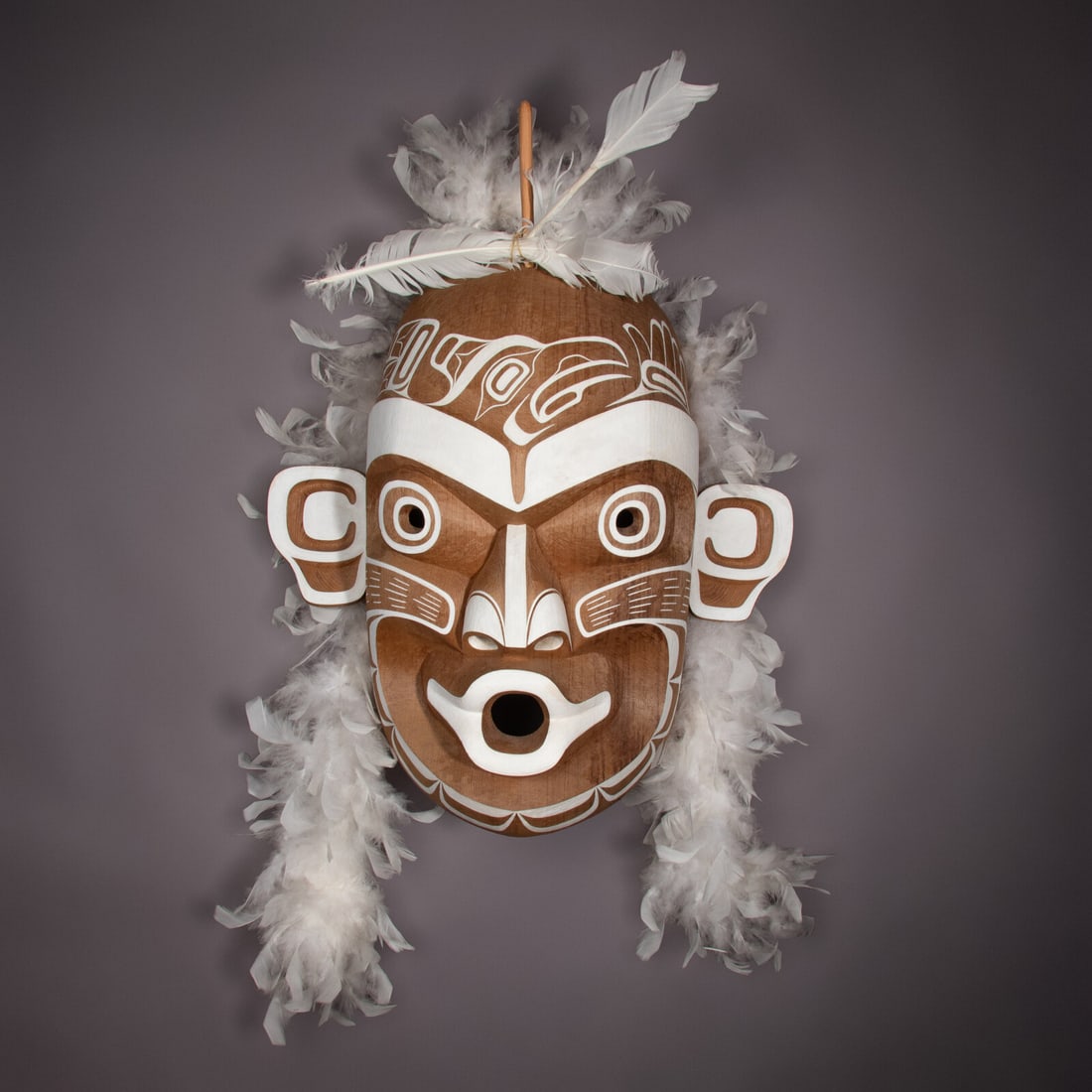 Tony Hunt Jr. (Canadian, 1962-2017) Kwagiulth Ghost Mask, 2002: Tony Hunt Jr. (Canadian, 1962-2017) Kwagiulth Ghost Mask, 2002 wood, feathers, white paint inscribed in pencil and signed in silver pen Tony Hunt Jr, 2002 on verso height 20 inches x width 18-3/4