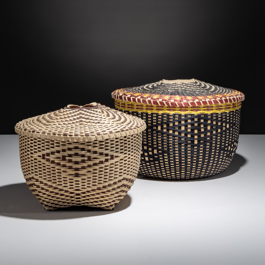 Fred Tomah (Maliseet, 1951-2018) Lidded Spit Ash Baskets2006 and 2012: Fred Tomah (Maliseet, 1951-2018) Lidded Spit Ash Baskets2006 and 2012 lot of 2, both signed and dated under rim, includes: The Katahdin Arctic Butterfly Basket woven in natural and dyed brown, featuri