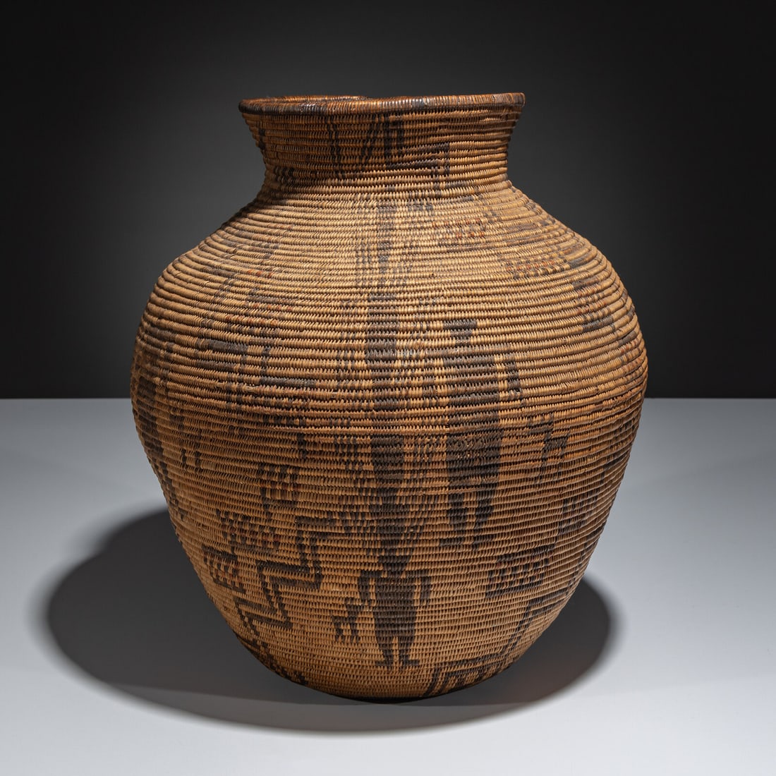 Apache Polychrome Figural Basket: Apache Polychrome Figural Basket first quarter 20th century decorated with four Mountain Spirits, seven humans, and fourteen dogs height 13-5/8 inches x diameter 12-1/2 inches With a copy of the