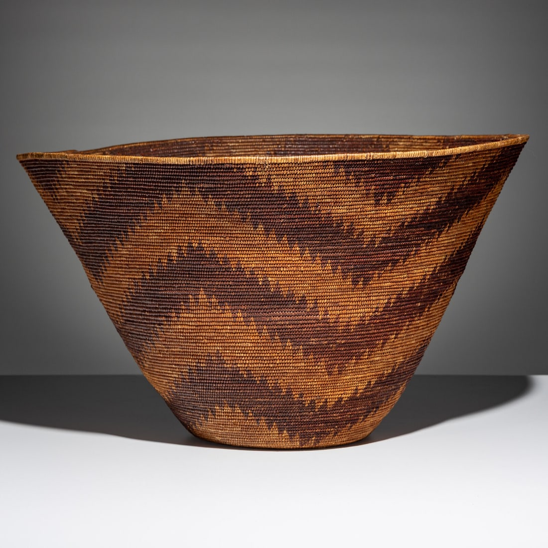 Monumental Maidu Basket: Monumental Maidu Basket early 20th century designed with zigzagging bands of redbud height 14 inches x diameter 23-1/2 inches From an Old Hollywood Family This lot is located in Chicago.