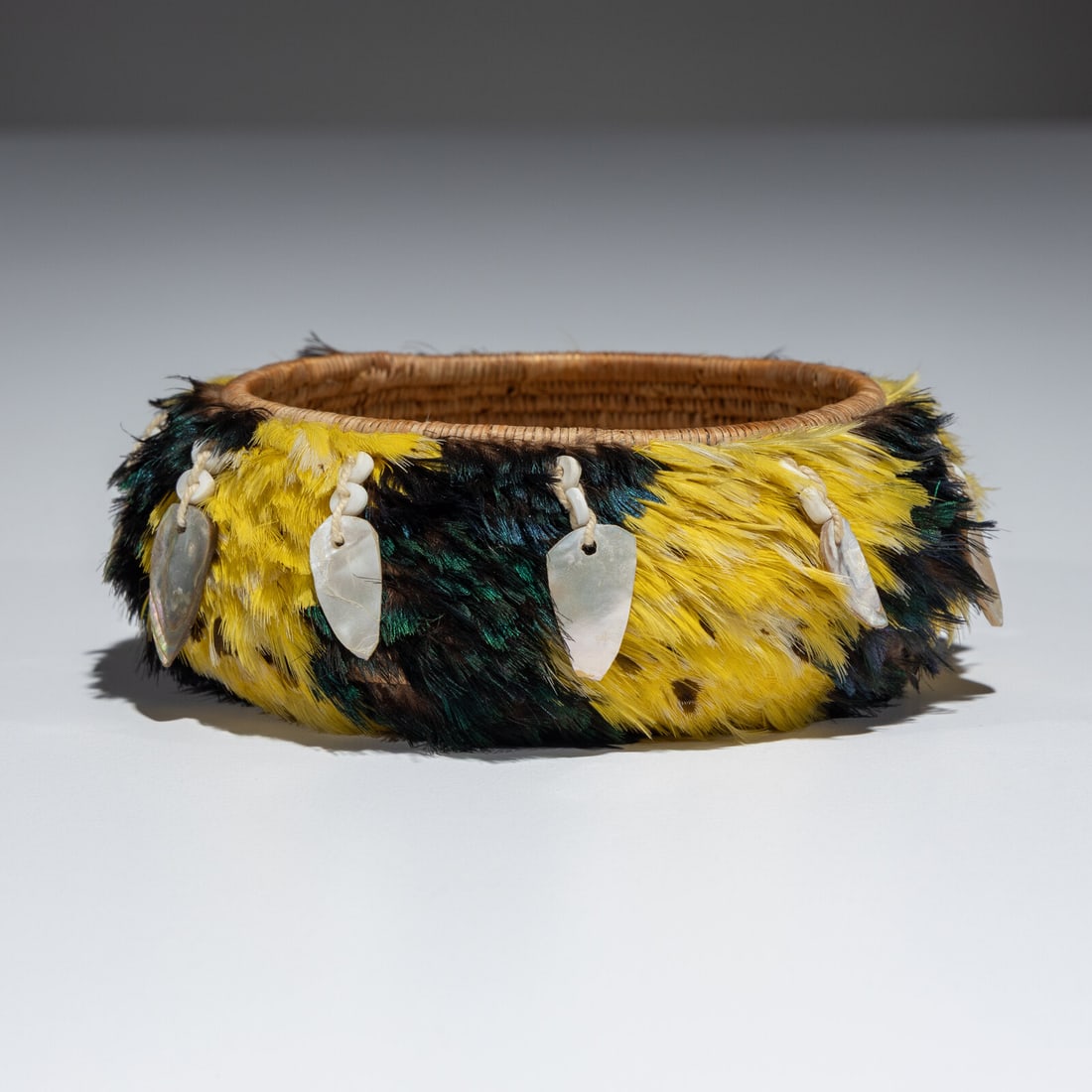 Pomo Gift Basket, with Old Collection Note: Pomo Gift Basket, with Old Collection Note early 29th century colorfully decorated and further adorned with abalone pendants suspended from the rim height 1-5/8 inches x diameter 4-1/2 inches