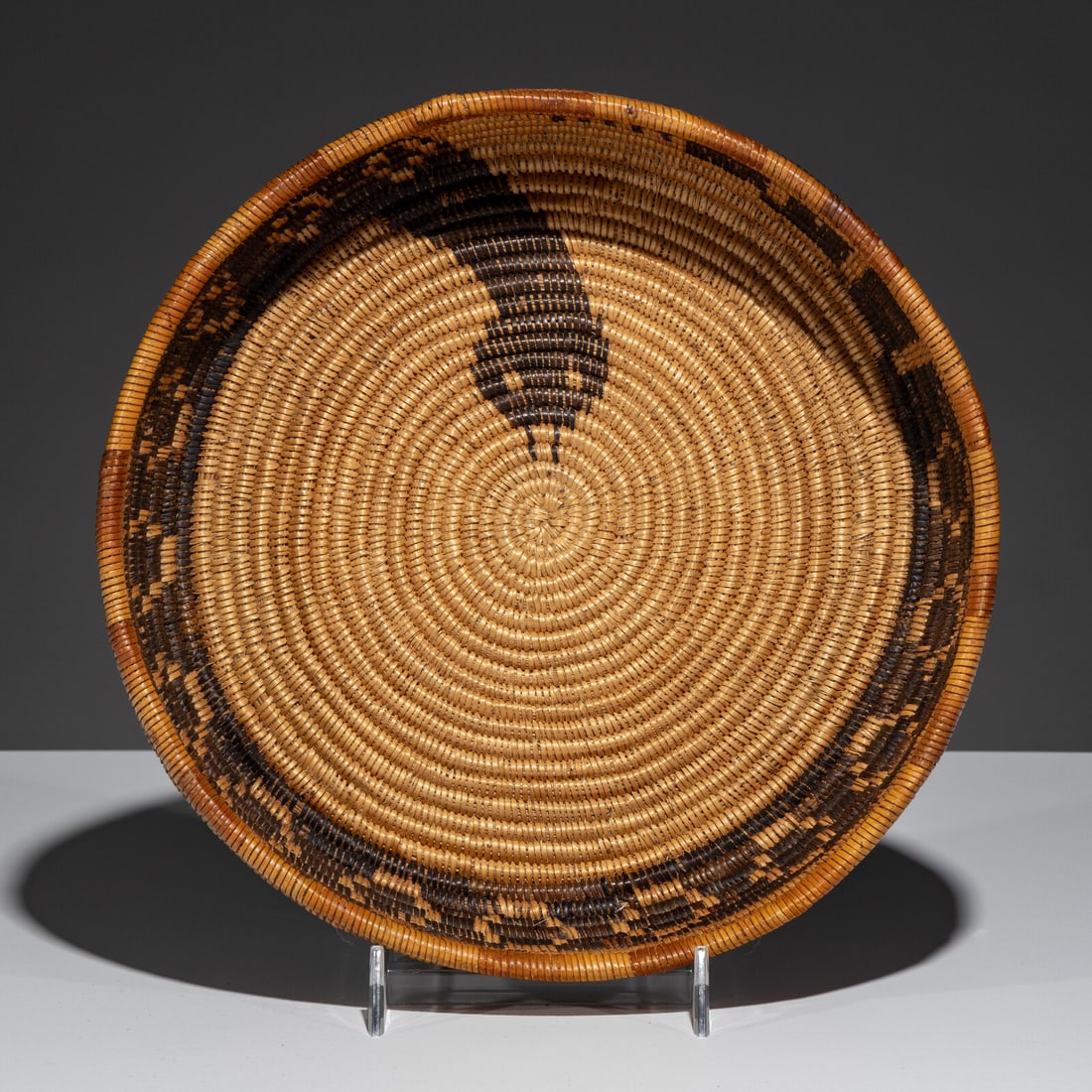 California Mission Basket, with Rattlesnake Design: California Mission Basket, with Rattlesnake Design early 20th century woven with Juncas and Devil's Claw; height 2 inches x diameter 9 inches From an Old Hollywood Family This lot is located in