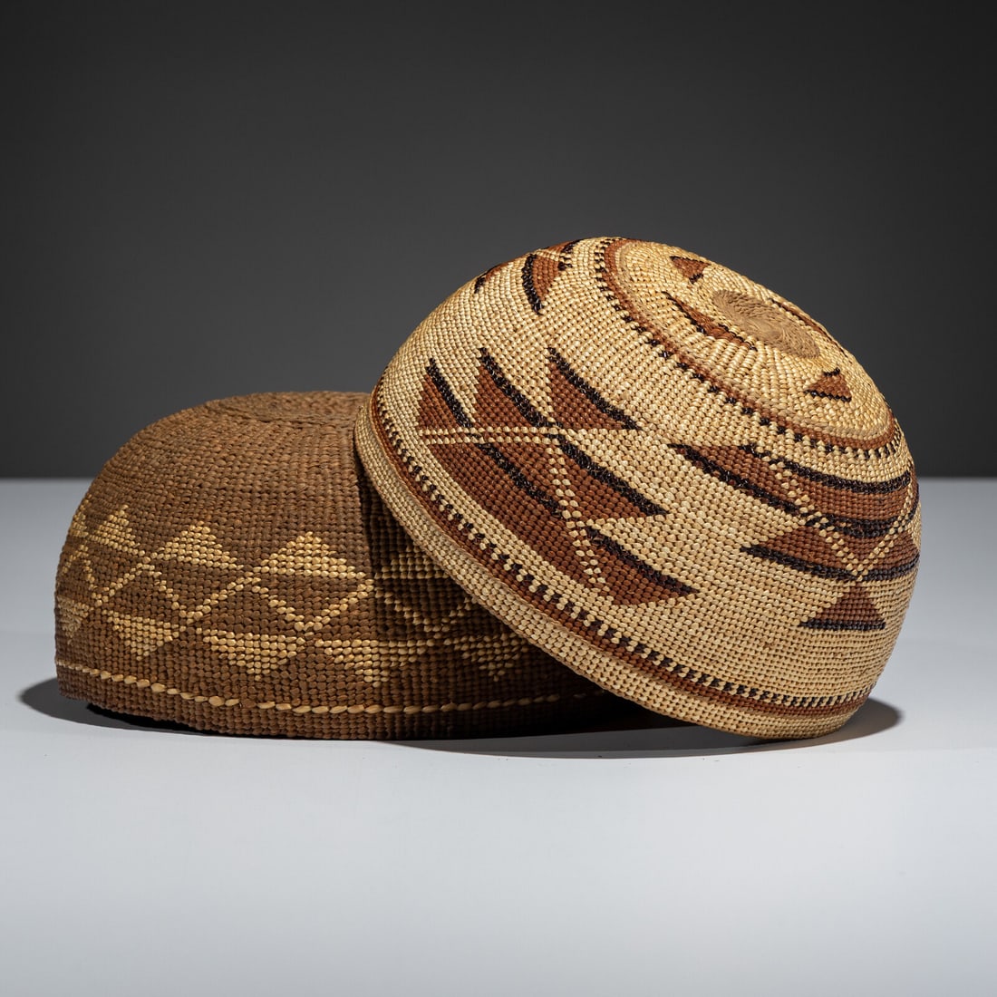 Northern California Basketry Hats: Northern California Basketry Hats early 20th century lot of 2, height 3-1/2 inches x diameter 6-3/4 inches AND height 3-1/2 inches x diameter 6-1/2 inches Property From a Private Virginia