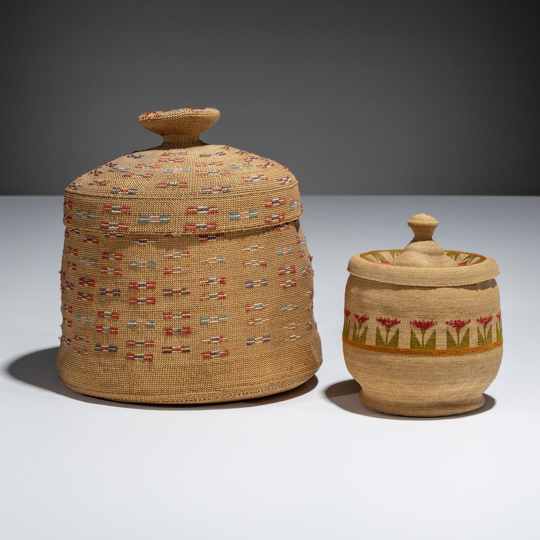 Attu Lidded Baskets: Attu Lidded Baskets first half 20th century lot of 2, includes: a lidded basket embroidered in colors of red, purple, blue, and cream; height 6-1/2 inches x diameter 5-3/4 inches a smaller, finely