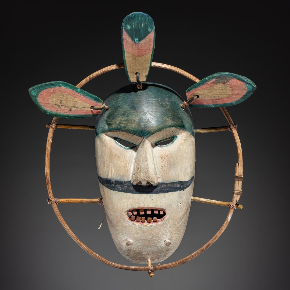 Yup'ik Dance Mask: Yup'ik Dance Mask early 20th century Hooper Bay Area, Alaska; carved wood and painted in white, blue, green, and pink; wood hoop; wood feathers attached using baleen; Yupik 4.3 inked on back overall