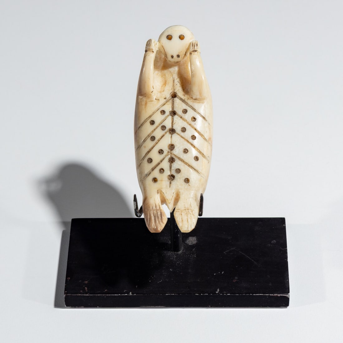 Inupiat Carved Kayak Toggle: Inupiat Carved Kayak Toggle late 19th century carved in the form of a sunning seal; back side pierced through for attachment length 2-3/4 inches x width 1 inch Ex Jeffery Myers Collection This lot