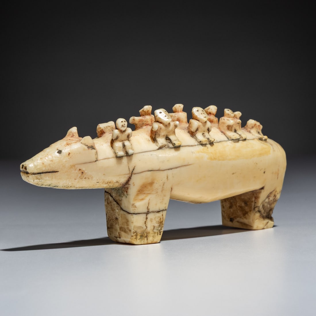 Inupiat Carved Bear with Ten Riders: Inupiat Carved Bear with Ten Riders late 19th century each human with inked facial features; remnants of red pigment height 2 inches x length 5-3/4 inches Ex Jeffery Myers Collection This lot is