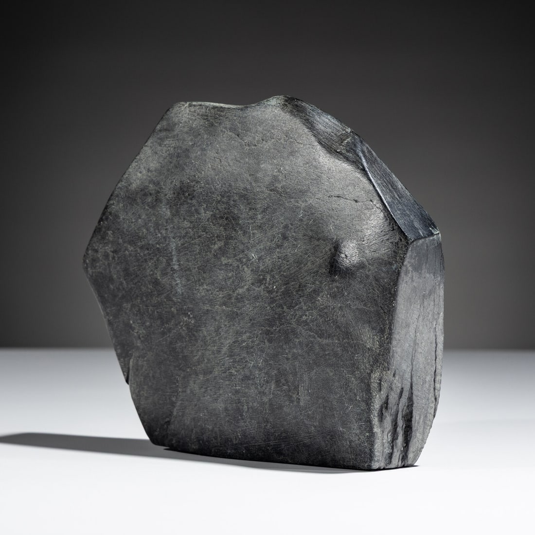 John Pangnark (Inuit [Arviat], 1920-1980) Bracing Muskox: John Pangnark (Inuit [Arviat], 1920-1980) Bracing Muskox steatite unsigned, marked K-2557 on base height 6-1/2 inches x length 7-3/4 inches x depth 1-1/2 inches This lot is located in Chicago. 