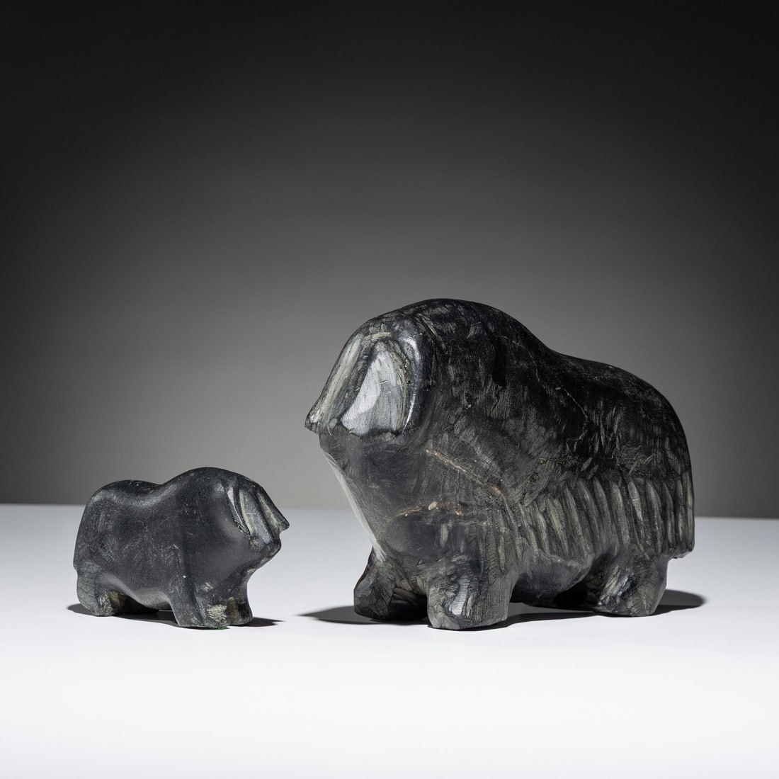 Mark Uqayuittuq (Inuit [Qamani’tuaq], 1925-1984) Muskox and Calf: Mark Uqayuittuq (Inuit [Qamani’tuaq], 1925-1984) Muskox and Calf stone lot of 2, each unsigned height 6-1/4 inches x length 10 inches x width 3 inches AND height 3 inches x length 5 inches x