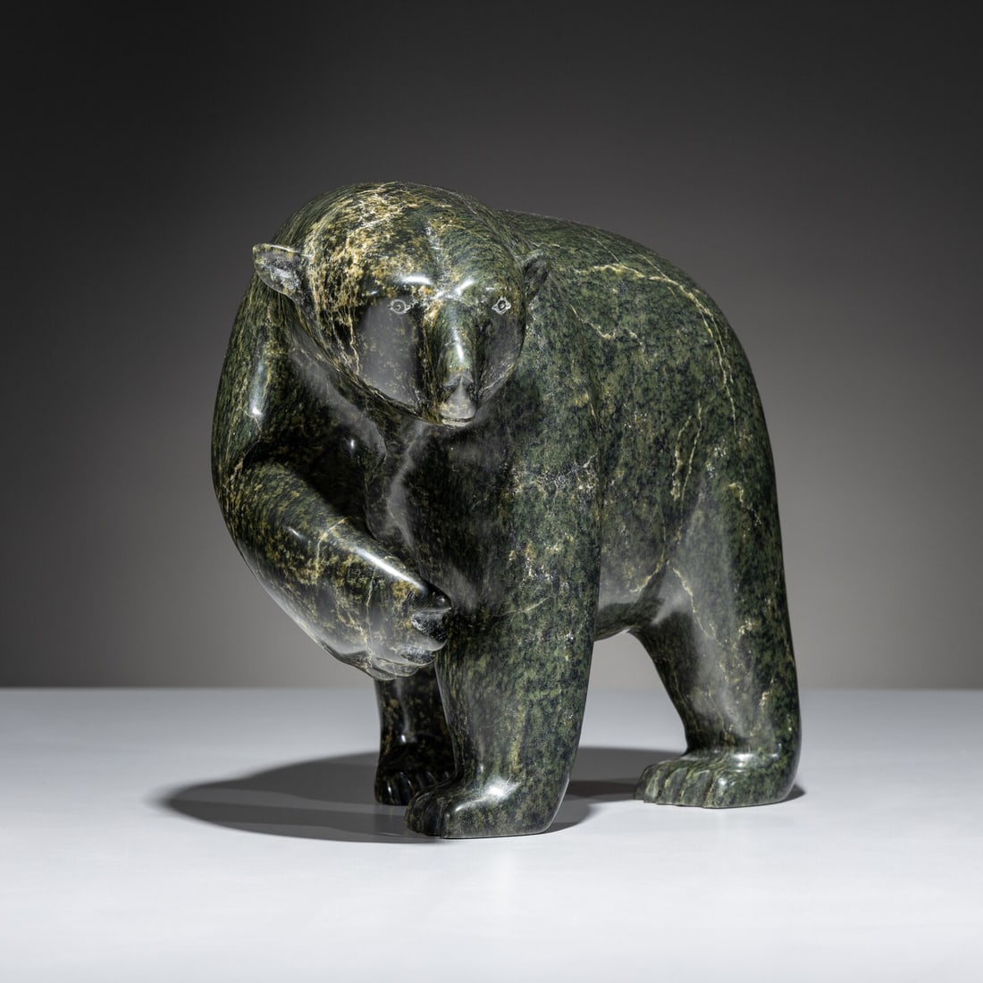 Ashevak Tunellie (Inuit [Kinngait], 1956-2018) Stalking Bear: Ashevak Tunellie (Inuit [Kinngait], 1956-2018) Stalking Bear soapstone signed in syllabics height 9 inches x length 11 inches x width 7 inches This lot is located in Chicago. Purchased from Alaska on