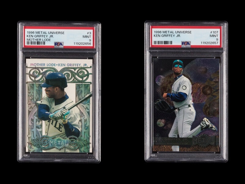 A Group of PSA Graded 1996 Metal Universe Ken Griffey Jr. Baseball Cards: A Group of PSA Graded 1996 Metal Universe Ken Griffey Jr. Baseball Cards comprising No. 107 (PSA 9 MINT) and No. 3 (PSA 9 MINT) This lot is located in Chicago. 