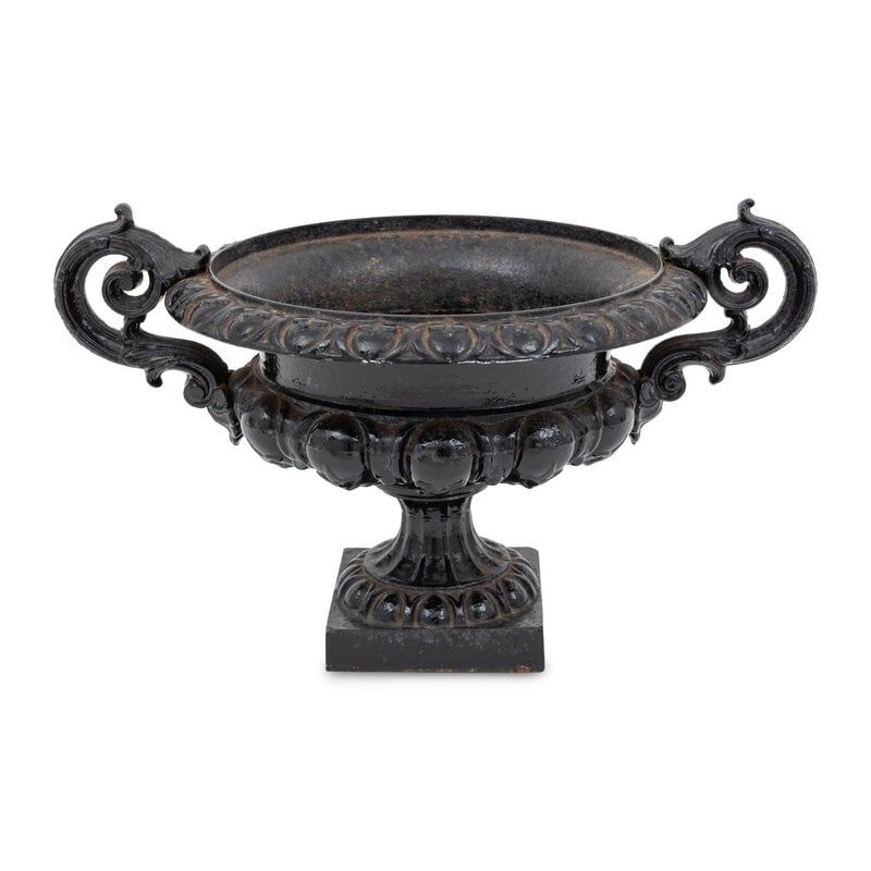 A Grecian Style Victorian Cast Iron Jardiniere: A Grecian Style Victorian Cast Iron Jardiniere Late 19th Century Height 11 1/4 x width 19 x diameter 13 1/2 inches. This lot is located in Palm Beach.