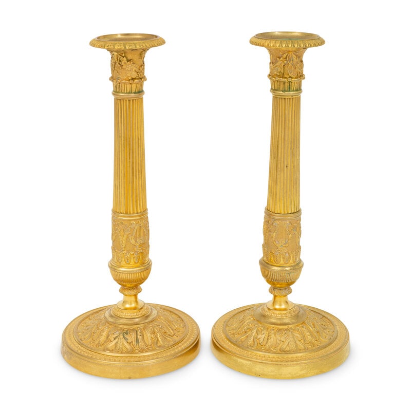 A Pair of French Neoclassical Gilt Bronze Candlesticks: A Pair of French Neoclassical Gilt Bronze Candlesticks First Half 19th Century Height 10 3/4 inches. This lot is located in Palm Beach. 