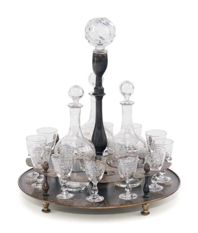 A Painted Tôle Cordial Caddy: A Painted Tôle Cordial Caddy 19th Century with three decanters and eleven cordial stems. Height of caddy 13 1/2 inches. Property from Camp Rosemary, the Estate of Posy Krehbiel, Lake