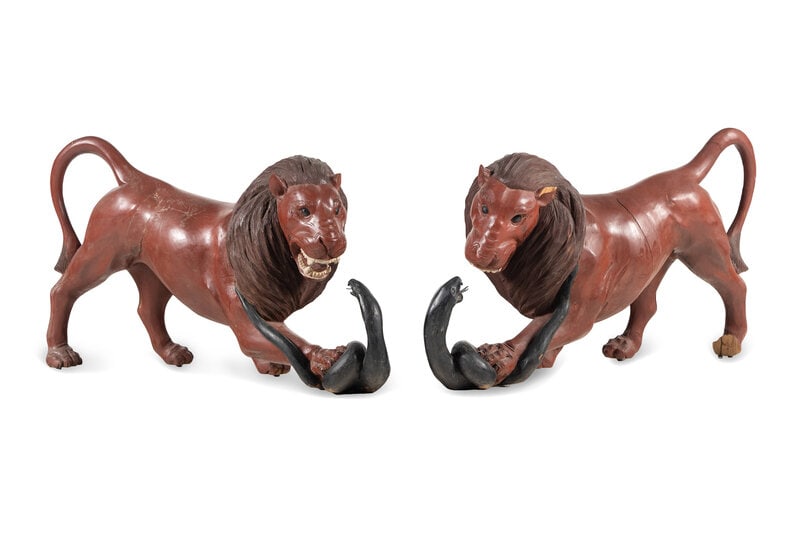 A Pair of Carved and Painted Wood Lions Wrestling Serpents : A Pair of Carved and Painted Wood Lions Wrestling Serpents 20th Century Height 28 x length 42 inches. Estate of the artist Philip Pearlstein (1924-2022), New York This lot is located in Chicago.