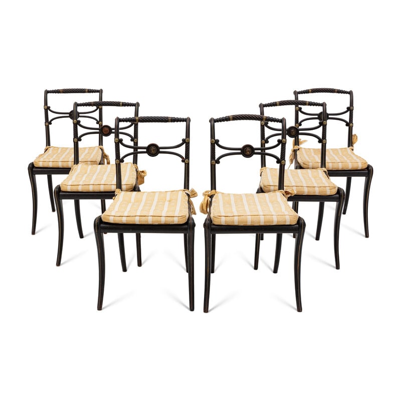 A Suite of Six Regency Ebonized and Caned Dining Chairs: A Suite of Six Regency Ebonized and Caned Dining Chairs Early 19th Century with gilt metal mounts; old paper labels under seat: Livermere Hall; each with a later seat cushion.Height