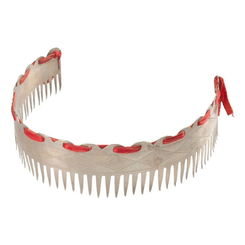 Menominee German Silver Rocker Engraved Hair Comb: Menominee German Silver Rocker Engraved Hair Comb early 20th century having a diamond design and laced with red satin ribbon length 6-1/4 inches This lot is located in Chicago. 