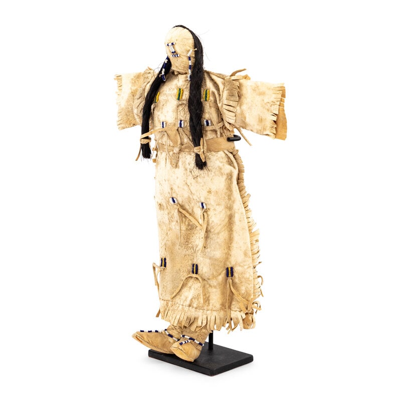 Plains Beaded Hide Doll: Plains Beaded Hide Doll late 19th century cotton cloth body with a hide head and horse hair braids; beaded hide dress and moccasinsheight 13 inches