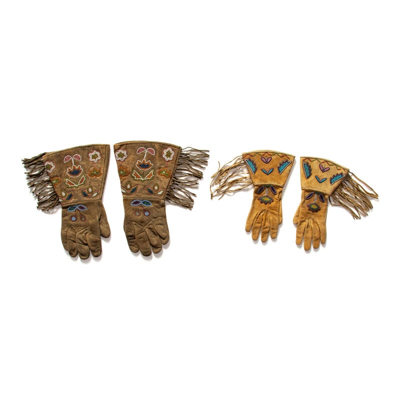 Apsáalooke [Crow] Beaded Hide Gauntlets: Apsáalooke [Crow] Beaded Hide Gauntlets early 20th century lot of 2, includes: a thread-sewn pair with floral designs on cuffs; patterned cotton lining, length 10-1/2 inches a larger,
