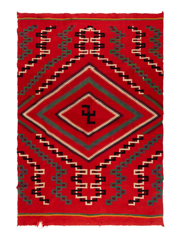 Navajo Germantown Weaving [Rug]: Navajo Germantown Weaving [Rug] ca 1900 woven with colors of red, green, cream, black, yellow, blue, and maroon; serrated diamond contains a central whirling log 64 x 46 inches The Ronny and Doris