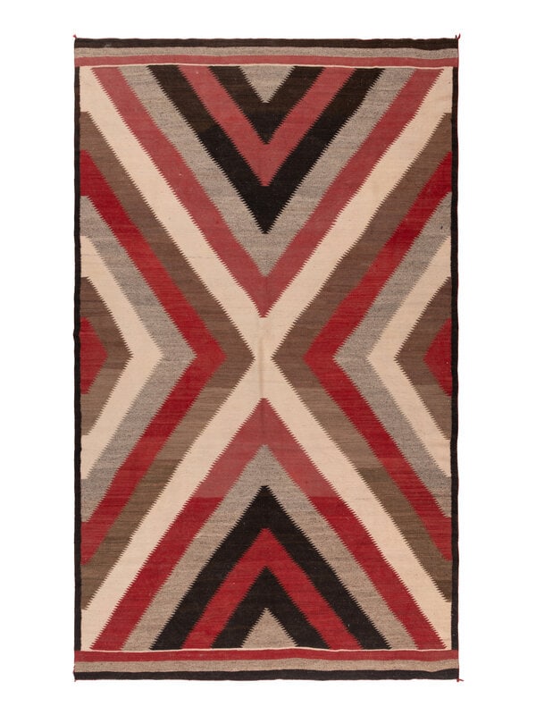 Navajo Western Reservation Weaving [Rug]: Navajo Western Reservation Weaving [Rug] second quarter 20th century handspun wool woven in colors of dark brown, tan, red, and cream; with an overall serrated X design 103-1/2 x 63 inches The
