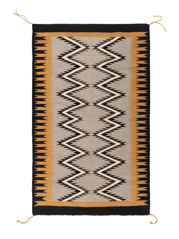 Navajo Eastern Reservation Weaving [Rug]: Navajo Eastern Reservation Weaving [Rug] mid-20th century handspun wool woven with a black border and swallowtail design elements along the border, serrated lightning pattern in center 49 x 31