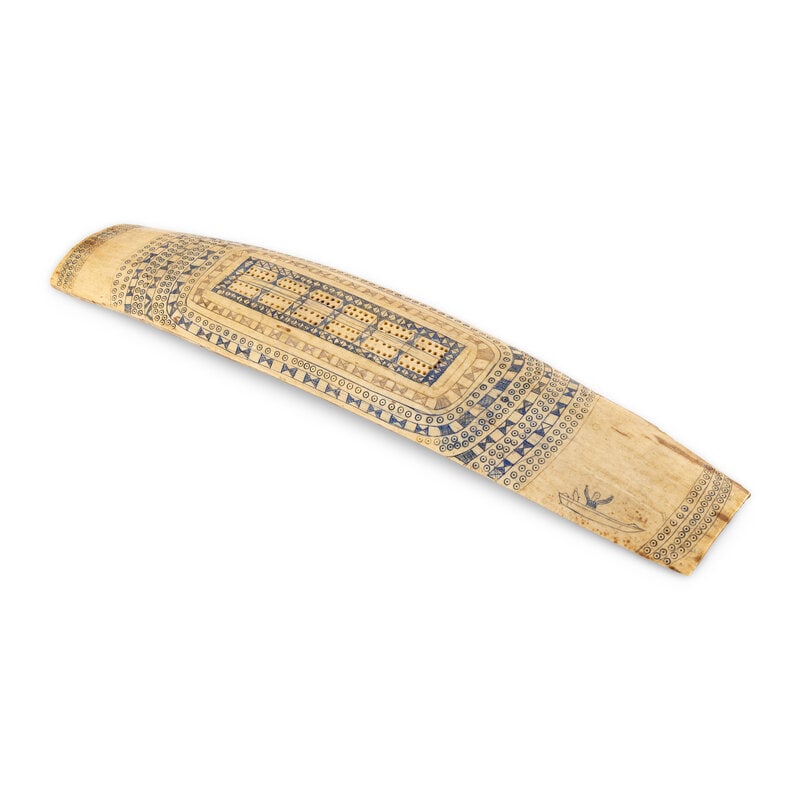 Siberian Yup'ik Polychromed Cribbage Board: Siberian Yup'ik Polychromed Cribbage Board ca 1900 decorated with hourglass, and dots-and-circle designs in black and blue pigments; underside pegged wood support boardlength 20-1/2 in