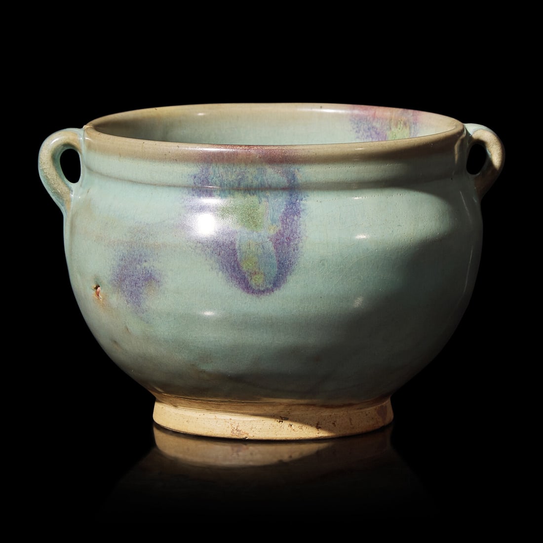 A Chinese Junyao Style Jar 鈞窯雙係罐: A Chinese Junyao Style Jar 鈞窯雙係罐 The jar features glaze in subtle sky blue, flanked by two handles. Height 4 1/4 in., 10.8 cm. This lot is located in Philadelphia.